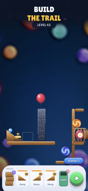 A Tumble Royale level in the build phase: a wooden shelf, a gap in the trail, a red balloon and a tray of ramp pieces waiting to be placed.